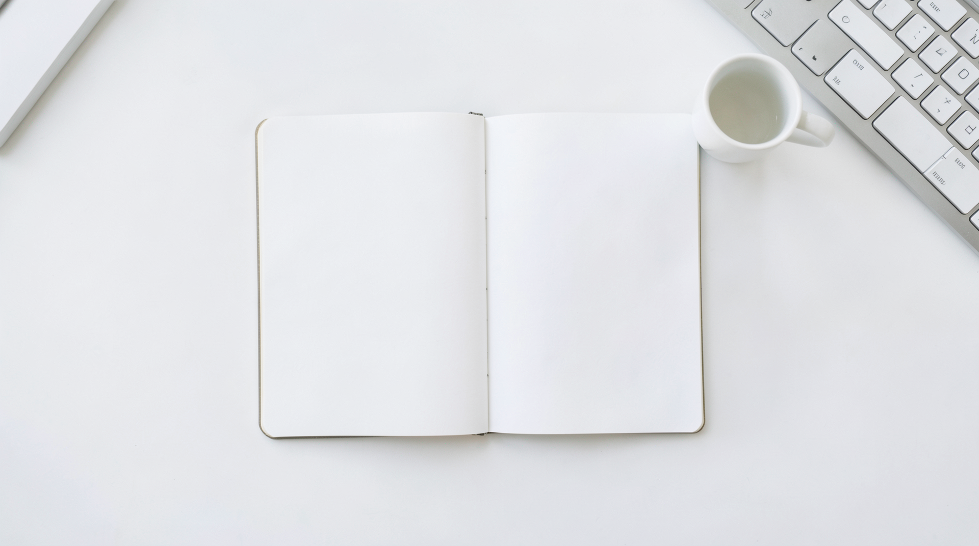 close-up of hands typing on mechanical keyboard with trading charts glowing on screen in background